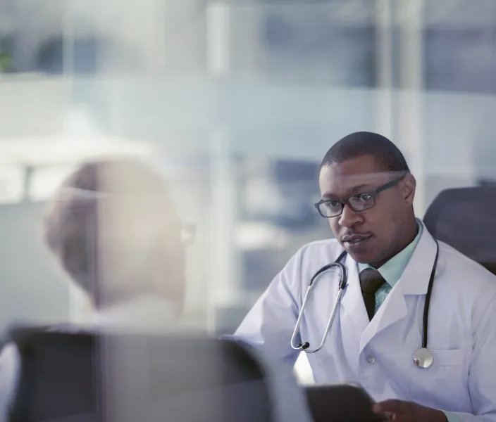 A doctor discusses something with a colleague