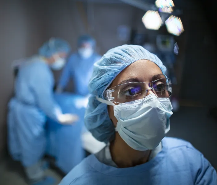 A doctor looks a medical information in an operating room