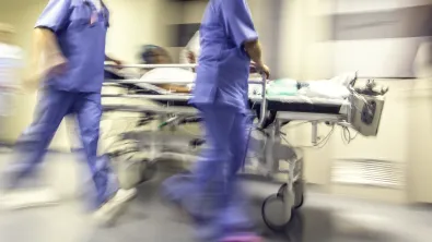 Doctors and nurses pulling hospital trolley