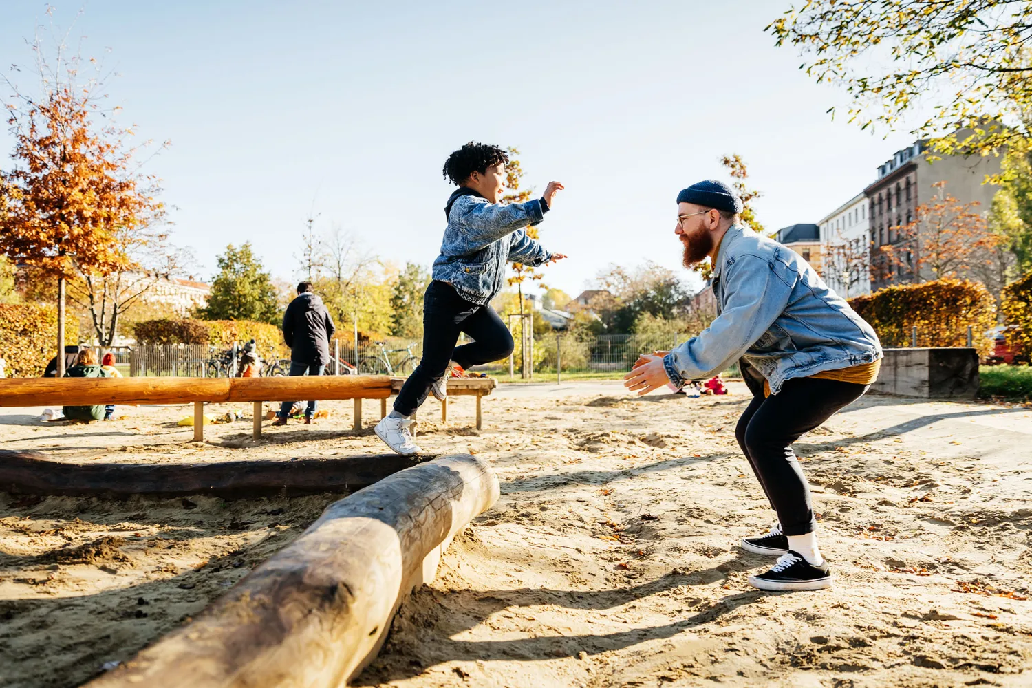 A father and son play in a park together